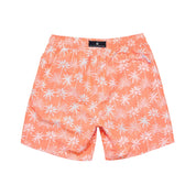 Peach-colored swim shorts with white floral pattern on a white background
