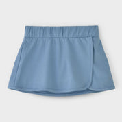 A blue tennis skirt with built-in shorts and a secure ball pocket, designed for performance and style.