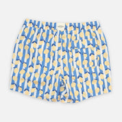Blue swim shorts with yellow abstract pattern on a white background